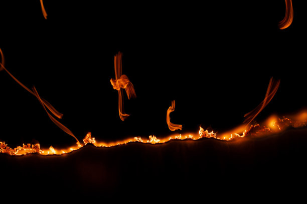 燃烧的纸，在黑色背景上发光的纸边图片下载