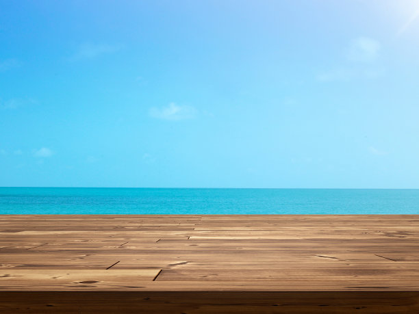 以天空和大海为背景的空木桌图片下载
