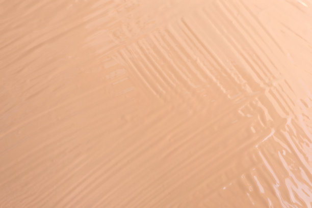 接近涂抹粉底纹理。化妆基础抽象组成涂抹纹理背景。图片下载