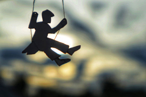 儿童骑在秋千上的剪影照片图片下载