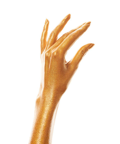 双手涂上金色的颜料。金手指。女性的手被孤立在白色背景上。白人女性放松的手显示符号和手势。图片下载