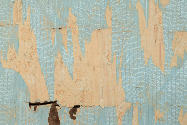 墙上的旧墙纸。旧的撕破的墙纸作为纹理或背景。图片下载