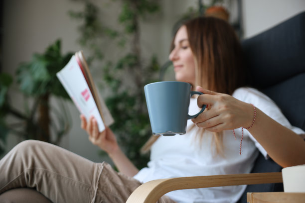 女人一边看书一边喝咖啡图片下载