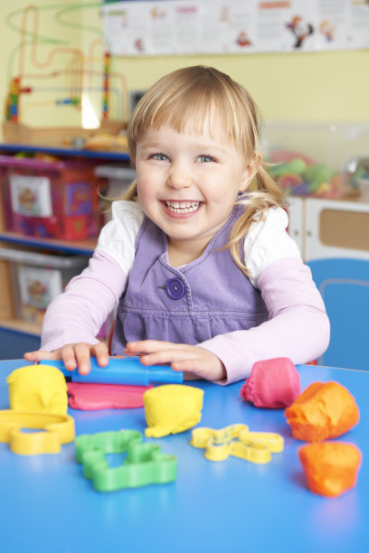 学前儿童在桌子上玩模型粘土图片下载