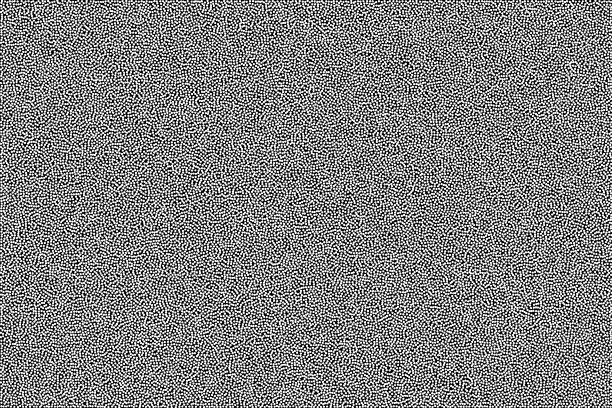黑色和白色颗粒抽象背景。半色调点画模式，在黑色背景上随机添加白点。图片下载
