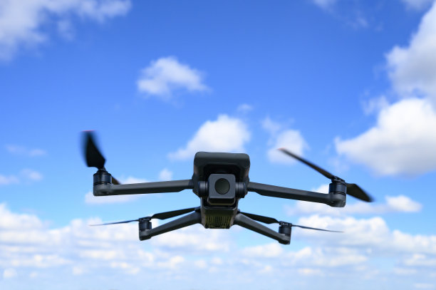 无人机在蓝天的背景下飞行。图片下载