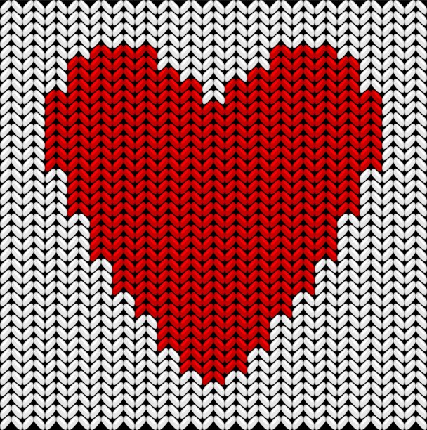 用白色背景的红色纱线编织的心图片下载