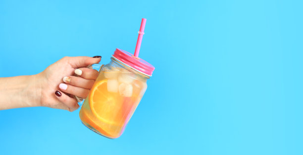 外卖柠檬水。一个女人的手拿着一个梅森罐图片下载