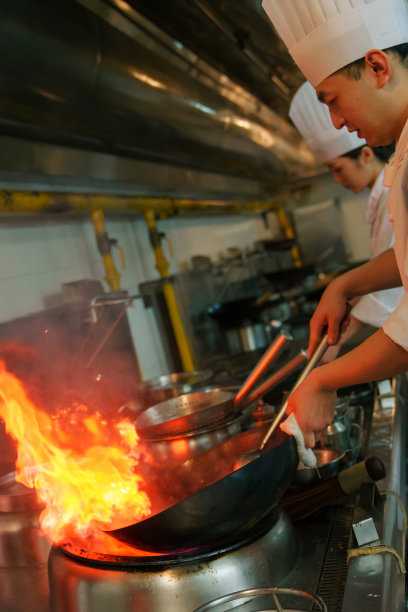 后厨内的专业厨师团队烹饪美味佳肴图片下载