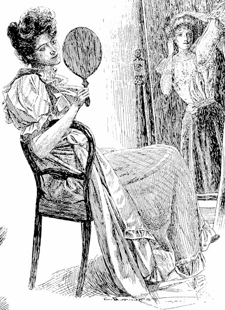 一位女士坐在椅子上看着一面手镜图片下载