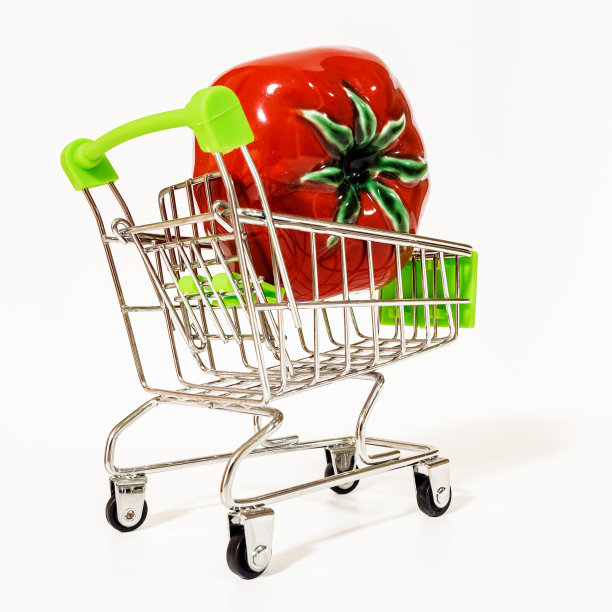 一个带轮子的超市手推车，里面有一个红色的番茄。图片下载