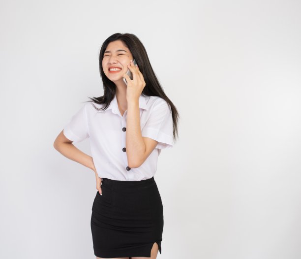 一个拿着手机的年轻亚洲女士的瞬间和表情图片下载