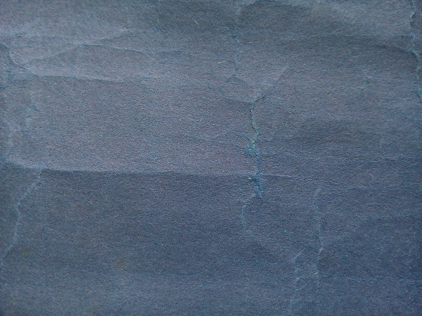 海军蓝皱纸纹理背景。图片下载