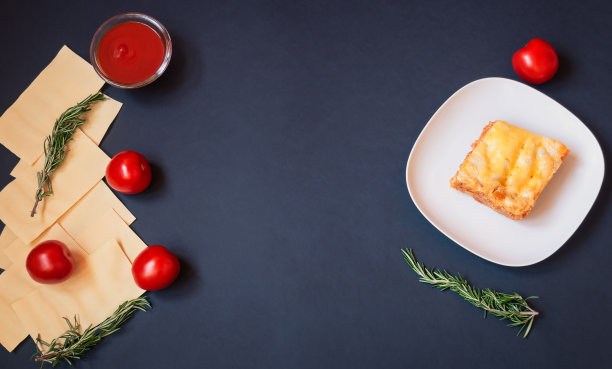 黑色背景上是千层面和一盘意大利肉酱千层面的原料。图片下载