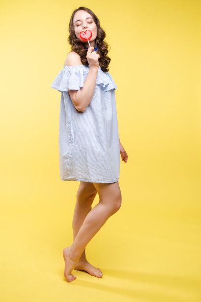 诱人的女人喜欢甜美的带糖娃娃。图片下载