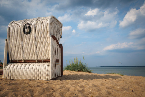 在波罗的海的岸边有一把白色的沙滩椅图片下载