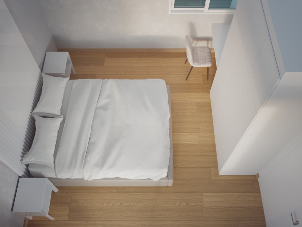 明亮卧室镶木地板上的床。图片下载