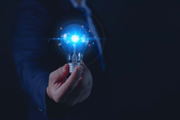 商人用技术持有新灯泡概念图片下载