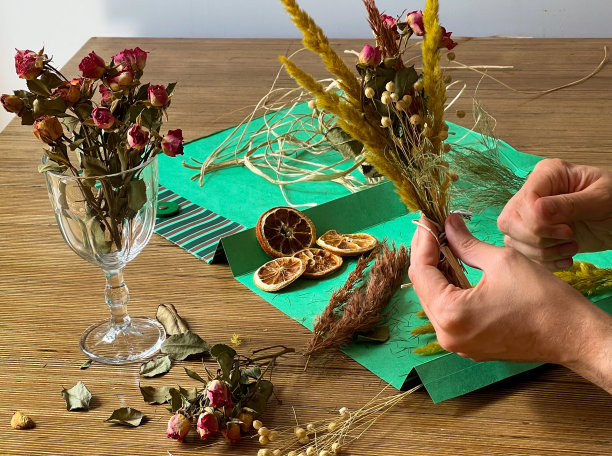 花店老板上班了。男人们正在制作一束干花。图片下载