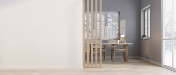 一个漂亮的简约餐厅，有木制餐桌和白色墙壁上的空白空间。图片下载