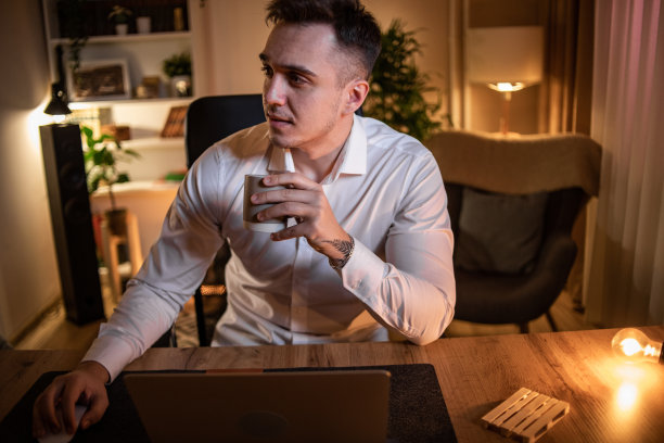 一个晚上在家工作的年轻人，在周围平静安静的时候工作图片下载