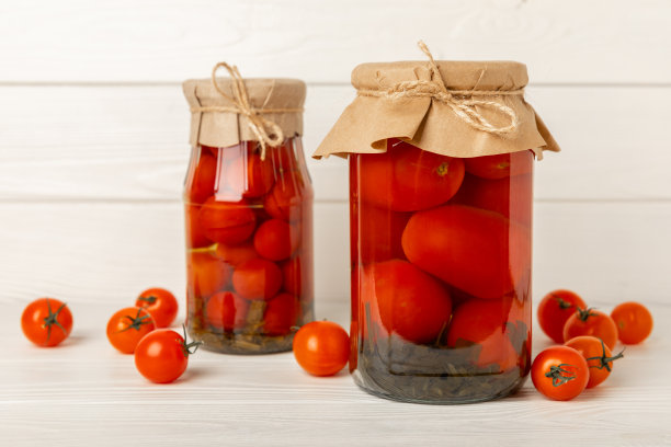 木制背景上的罐子里的腌西红柿。食品供应。健康食品。收割。副本的空间。放文字的地方。图片下载