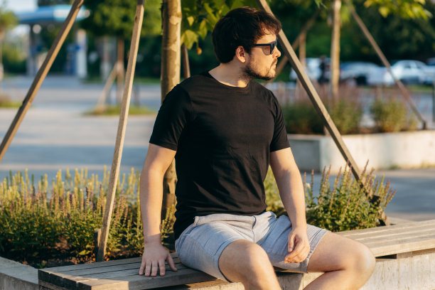 穿着黑色t恤，戴着墨镜的年轻时髦的大胡子男人。街头的照片图片下载
