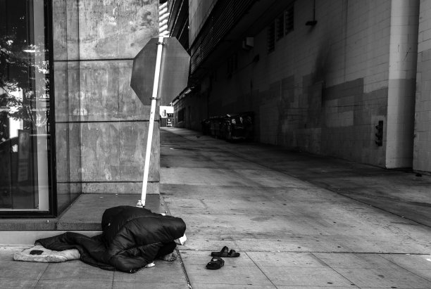 无家可归的人在阳光下睡在人行道上图片下载