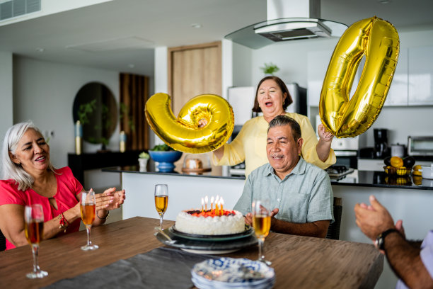 朋友和妻子在家里唱生日快乐歌庆祝一位老人的生日图片下载