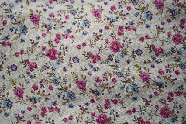 可爱的亚麻织物与花卉图案，粉红色和蓝色的花朵在米色的材料图片下载