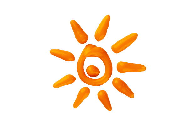 橙色的防晒霜在白色的背景上形成太阳的形状。图片下载