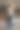 照片中一名女子身穿蓝色牛仔裤和白色上衣，手拿棕色皮包。图片下载