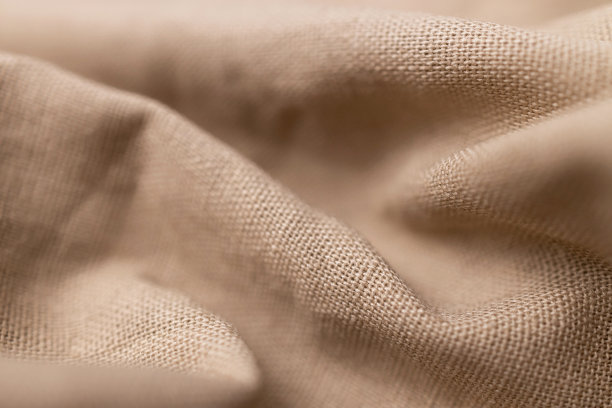 天然亚麻织物质感。粗糙皱巴巴的粗麻布背景图片下载