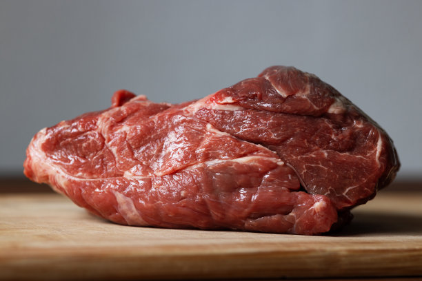 生肉。切菜板上的一大块牛肉图片下载