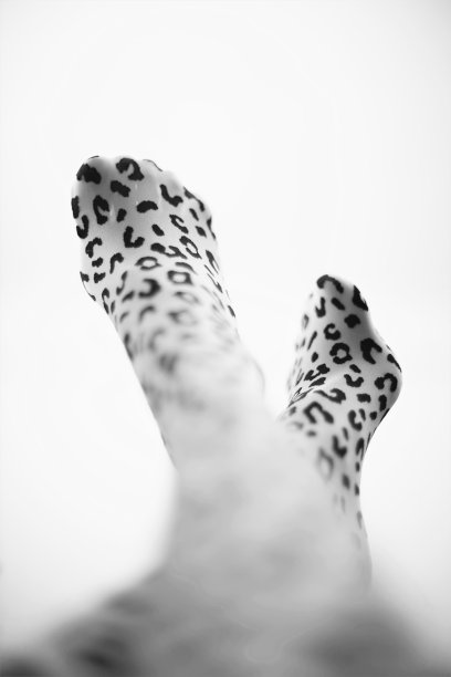 穿着豹纹紧身衣的女性腿特写。黑白照片。图片下载