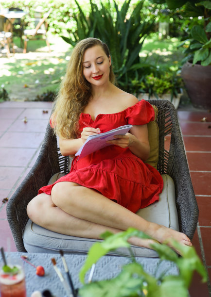 美丽的金发女郎，艺术家和插画家，坐在沙发上思考绘画的想法图片下载