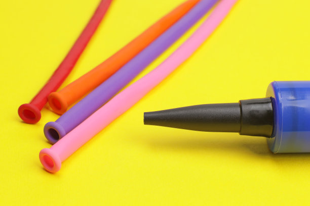 黄色背景上的气泵和气球图片下载