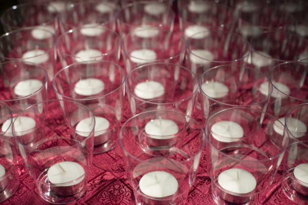 玻璃杯里的蜡烛。桌子上有很多蜡烛。透明杯子的质感。图片下载