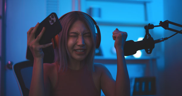 亚洲年轻的电子竞技女性玩家喜欢在智能手机上玩在线游戏。图片下载