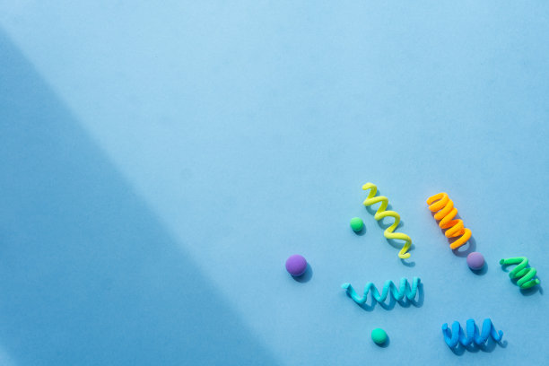 由橡皮泥、螺旋和不同大小的球组成的彩色抽象人物。有趣的插图为儿童节日的背景，框架为文字图片下载