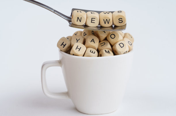 杯子里有写着字母的方块，勺子上有写着“新闻”字样的方块图片下载