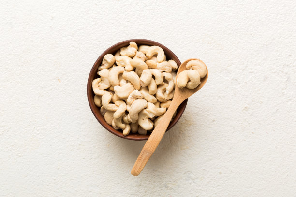 餐桌背景上木碗里的腰果。前视图。健康食品图片下载