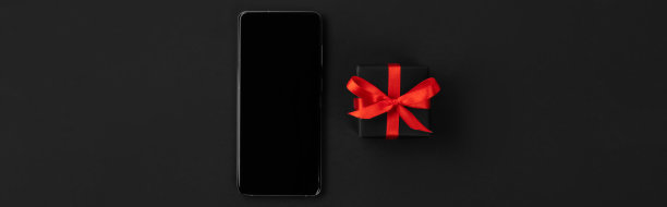 平放顶视图组成智能手机和礼物。黑色星期五购物销售模型图片下载