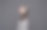 无忧无虑迷人的黑发女孩，穿着灰色毛衣，戴着耳机听音乐，站在灰色的背景上图片下载