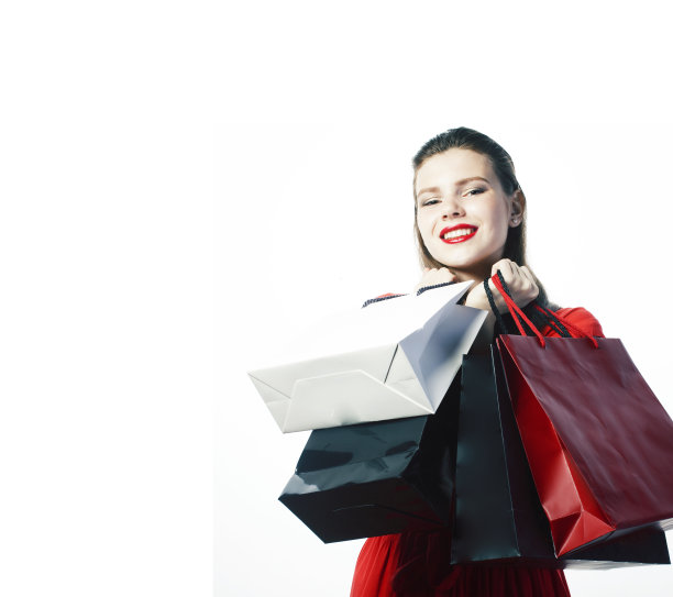 年轻漂亮的金发女子摆出愉快的孤立在白色背景与包圣诞销售红色连衣裙图片下载