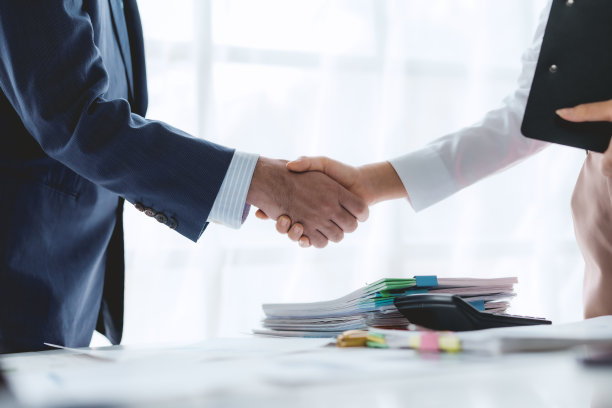 商业上的成功。商务人士握手协议确认在投资业务。成功的商业人士聚在一起。图片下载