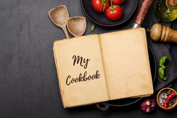 从上到下的视图，厨房的桌子上有食材、器具和一本打开的食谱图片下载