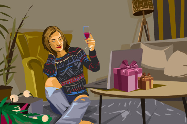 一个圣诞节坐在笔记本电脑前喝酒的女人图片下载
