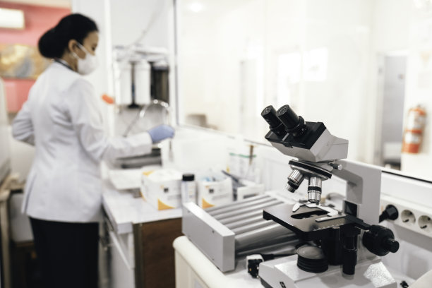 图片聚焦显微镜与亚洲女科学家在后台工作图片下载