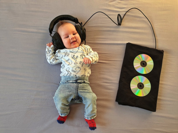 婴儿戴着耳机躺在床上图片下载